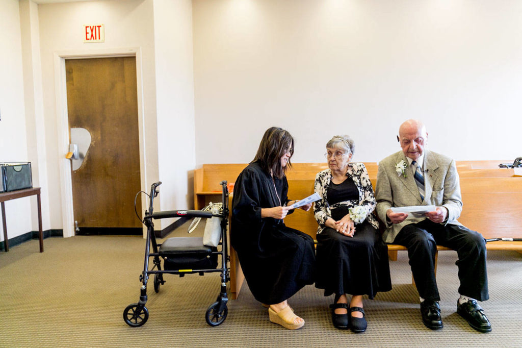 Judge Tam Bui talks with Marilyn Ogden and Kal Leichtman before their wedding ceremony Wednesday at the Snohomish County Courthouse in Everett. (Kevin Clark / The Herald)
