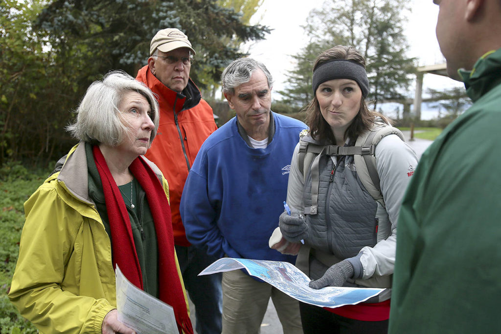 Area residents Joan Smith, (L-R) Gregg Lungren, Mike Gold and Emily Mydynski talk with Todd Zackey over the proposed high density development and the effects on the existing stream and erosion at Picnic Point County Park in Edmonds on Nov. 6, 2015. (Kevin Clark / Herald file)
