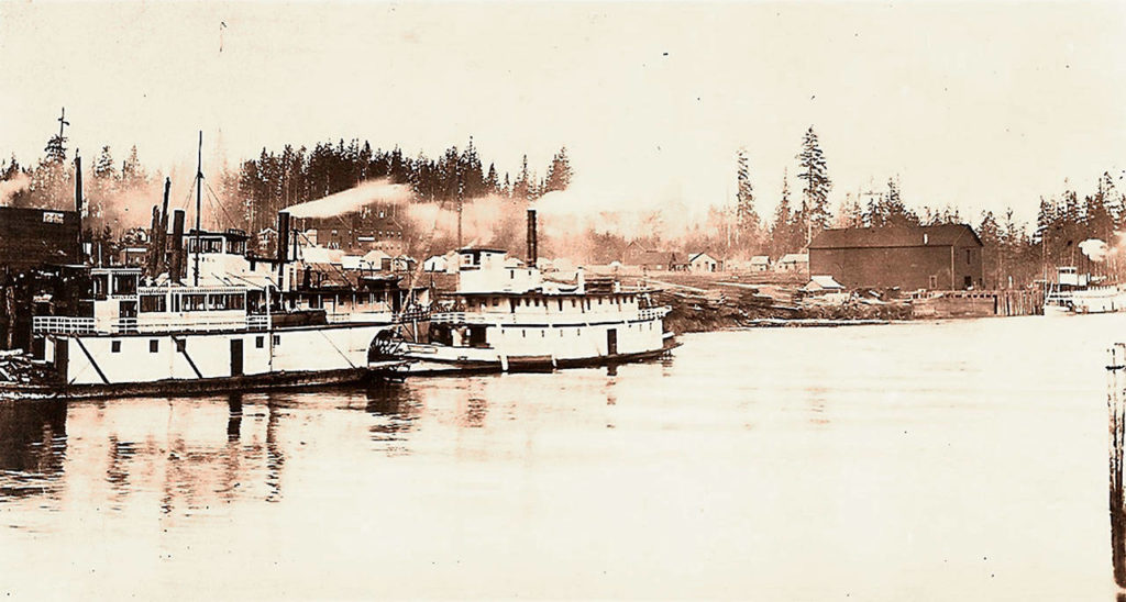 Steamboats at Hewitt Avenue with a dock on the Snohomish River, from Feb. 1, 1892. Historian Jack O’Donnell will present a photo show of Everett’s working waterfront, then and now, Saturday at the Port of Everett. Later, there will be a ribbon cutting and bike ride on the new Mill Town Trail. (Courtesy Historic Everett)
