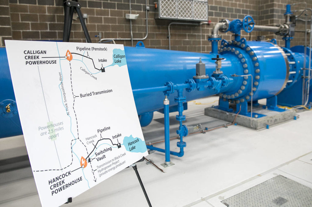 The large blue pipes carry the water to the turbine inside the Calligan Creek Hydro Project powerhouse in King County. (Lizz Giordano / The Herald)

