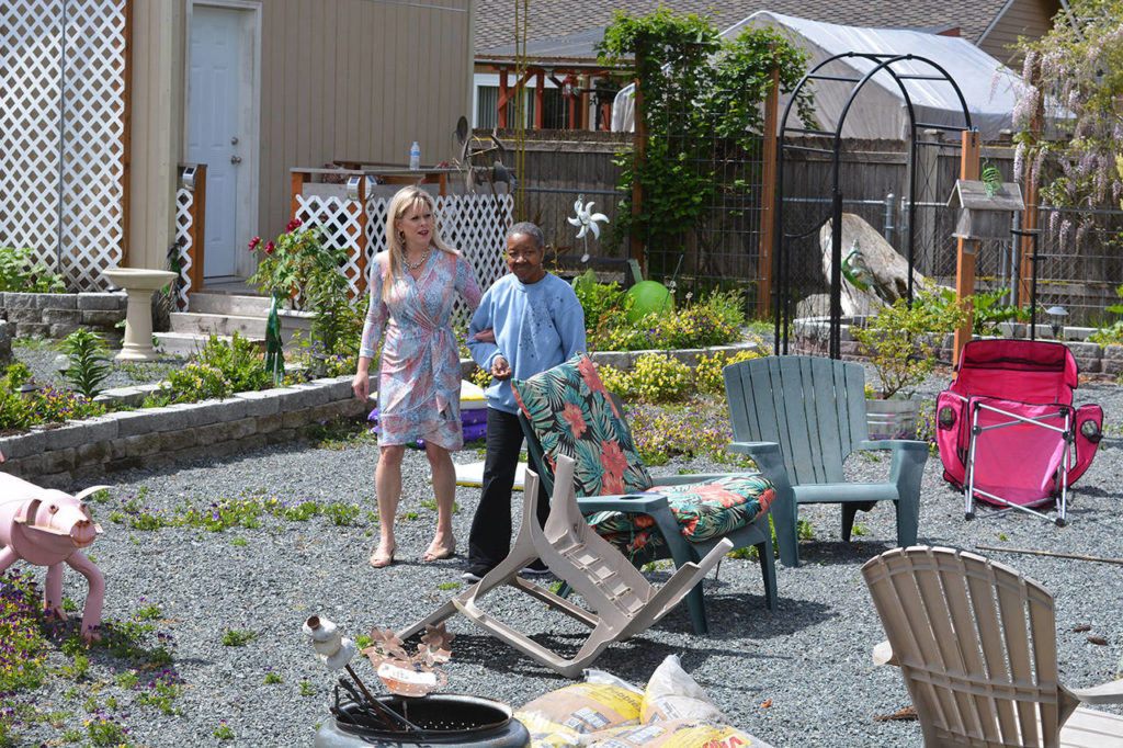 Amy Marohn walks “Dimples” around the back yard at Katie’s daycare. (Steven Powell / Marysville Globe)
