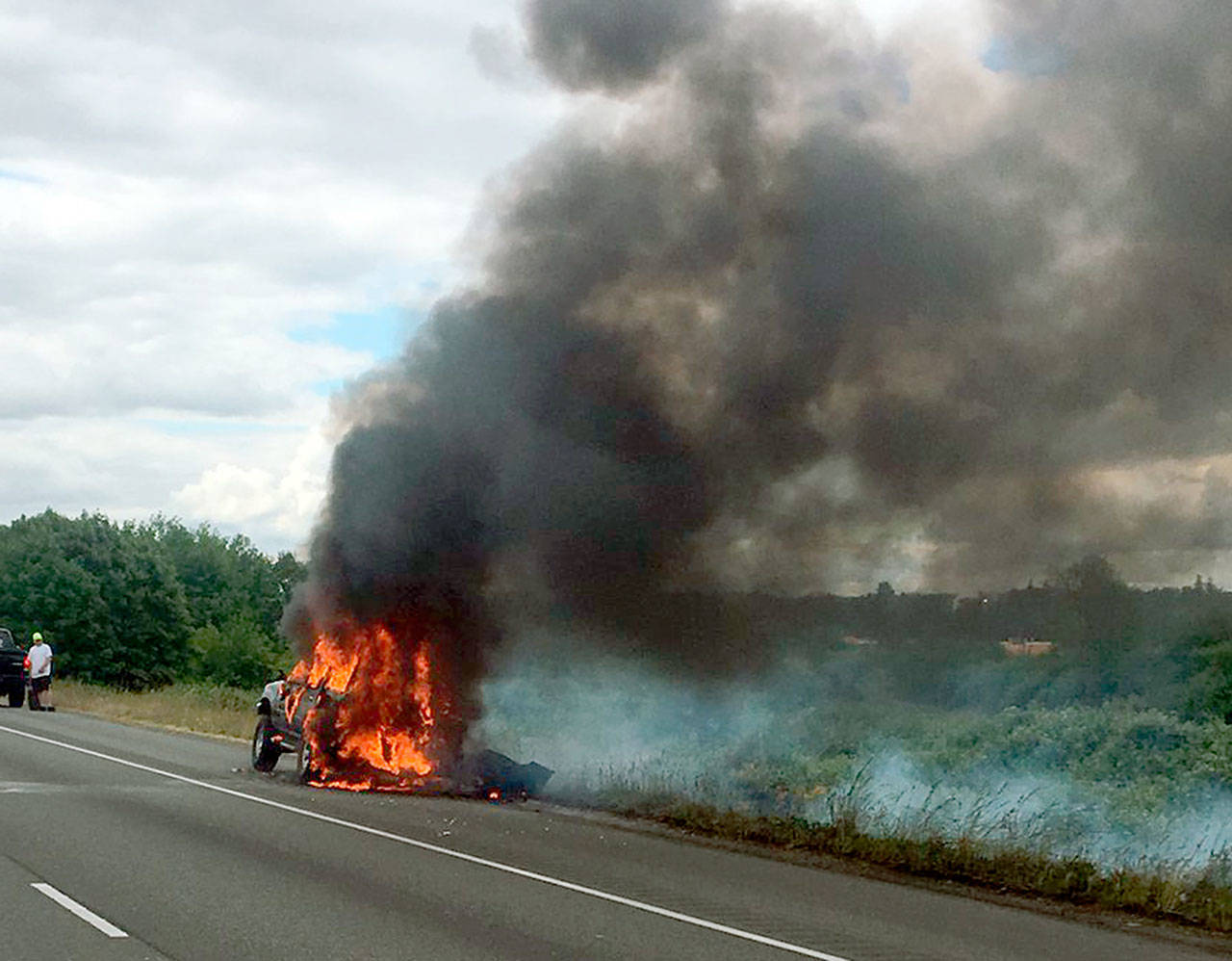 An SUV burns on southbound I-5 south of Marysville on Friday. (Washington State Patrol)