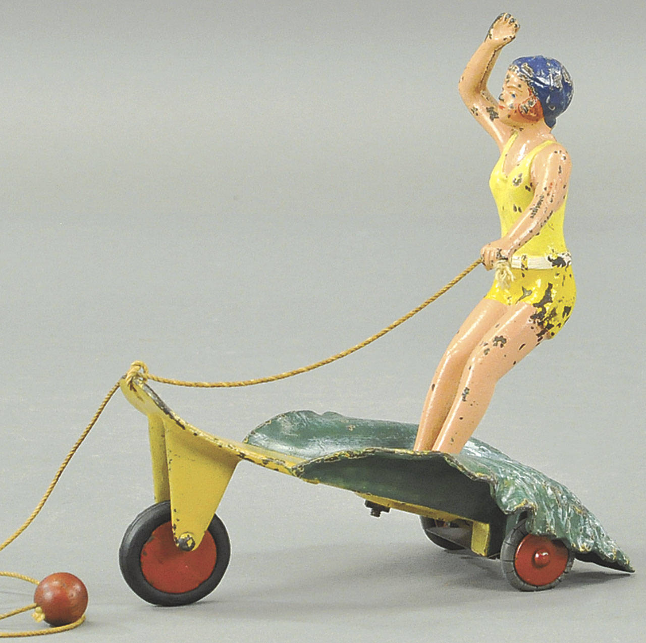 Surfer toys are rare even today. This 8-inch-high vintage metal toy auctioned by Bertoia Auctions recently probably was made about 1960. (Cowles Syndicate Inc.)