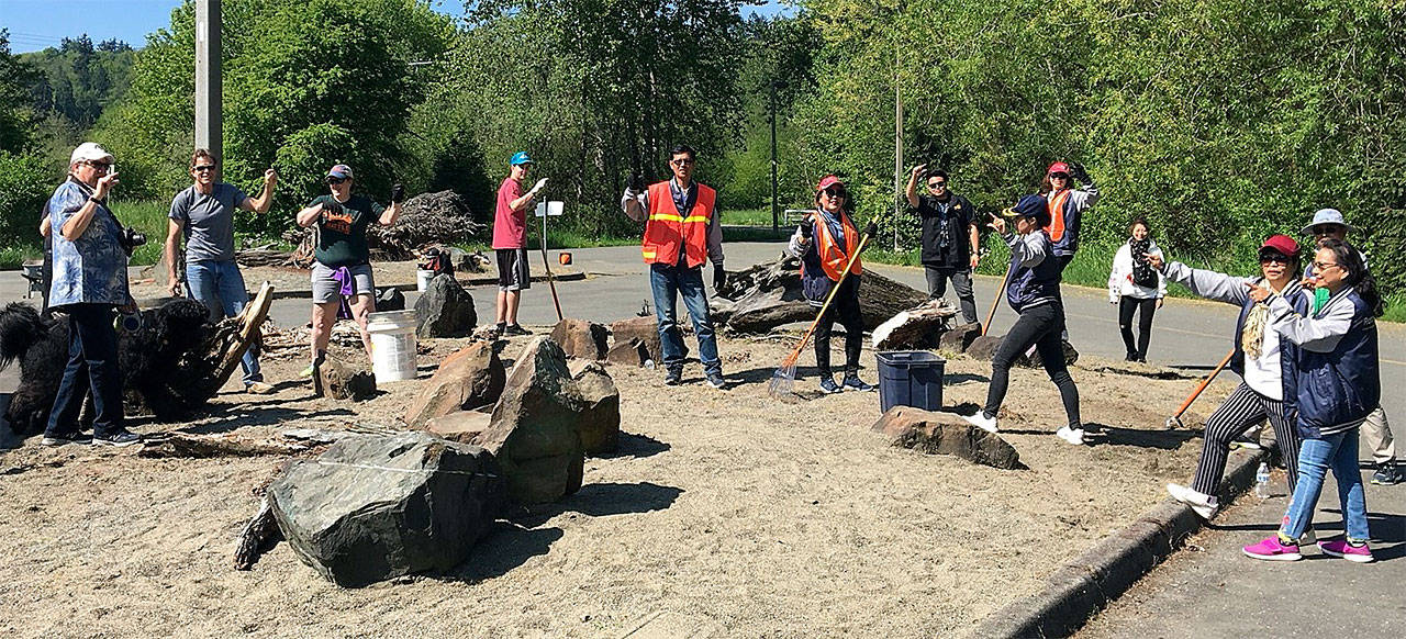 Visiting Rotarians from Thailand joined 32 local volunteers from the Rotary Club of Everett and other organizations on May 5 to clean up Rotary Park near Lowell. (Contributed photo)