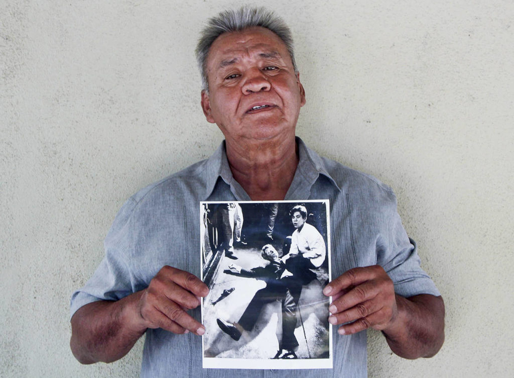 At his home in Modesto, California, Juan Romero, 67, holds a photo of himself and the dying Sen. Robert F. Kennedy at the Ambassador Hotel in Los Angeles, taken by the Los Angeles Times’ Boris Yaro on June 5, 1968. (Jud Esty-Kendall/StoryCorps via AP)
