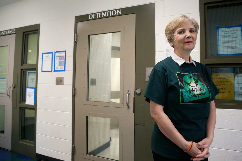 Arts With A Purpose Director Alison Herron talks about how little arts education most of the teens in detention have received and how well they respond to it at Denney Juvenile Justice Center. (Dan Bates / The Herald)
