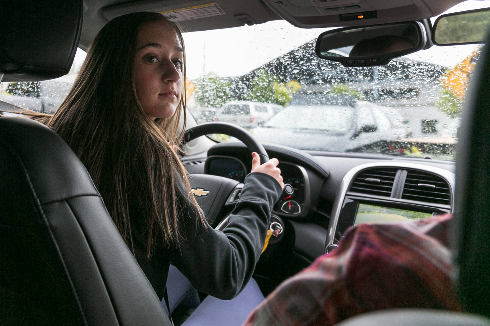 Olivia Kraski takes a turn at the wheel in the driver’s education class at Arlington High School on Friday. (Kevin Clark / The Herald)