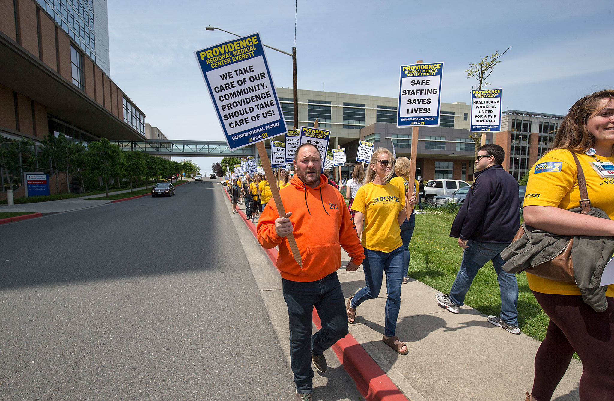 Nurse Katy Roth and her husband, Rod, a union member with Labor Local 292, walk hand in hand as they and other nurses with UFCW 21 picket at Providence Regional Medical Center Everett on Wednesday. (Andy Bronson / The Herald)