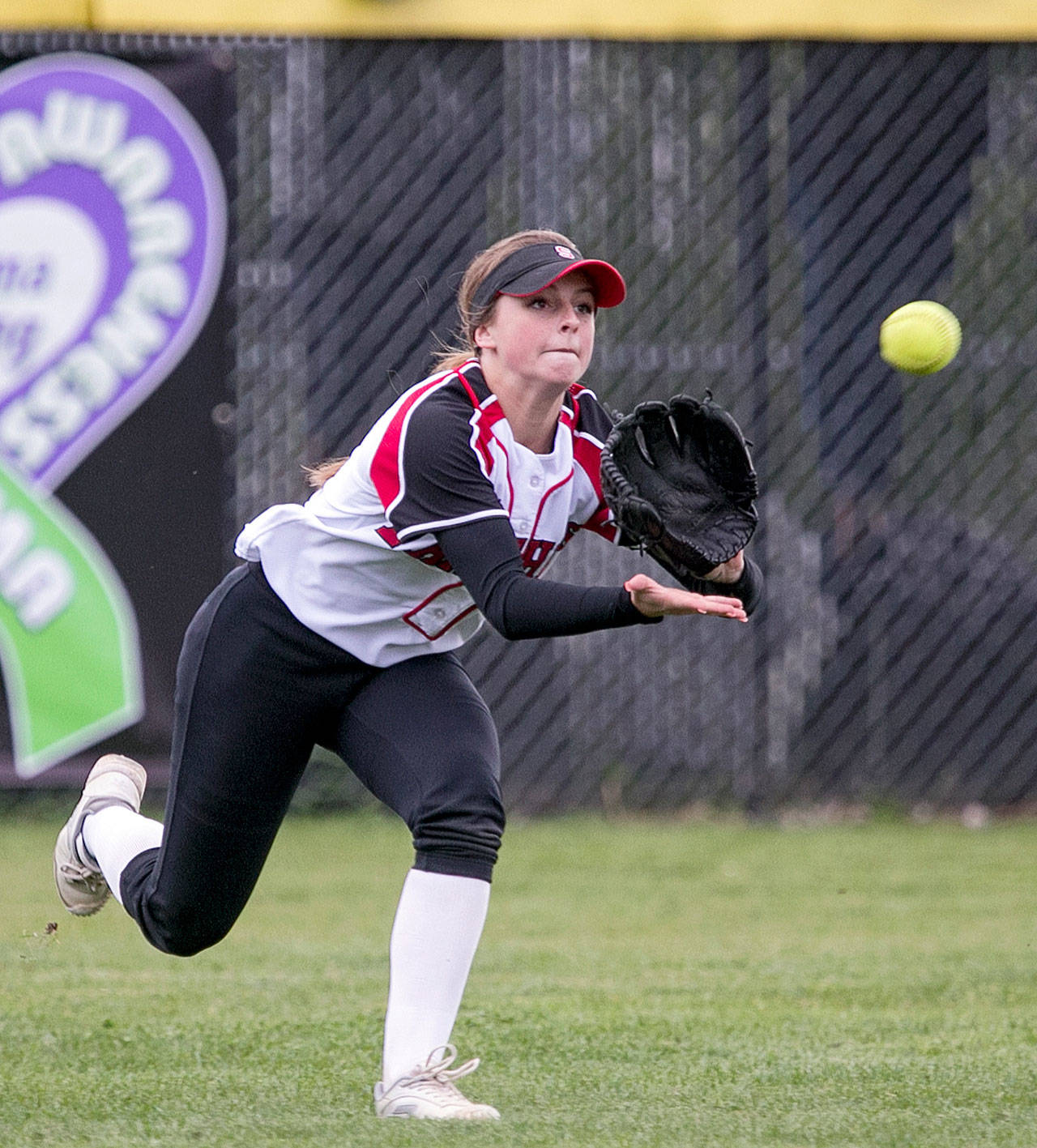 UW-bound senior Sami Reynolds of Snohomish High School makes a play in the outfield during a game in April. (Kevin Clark / The Herald)