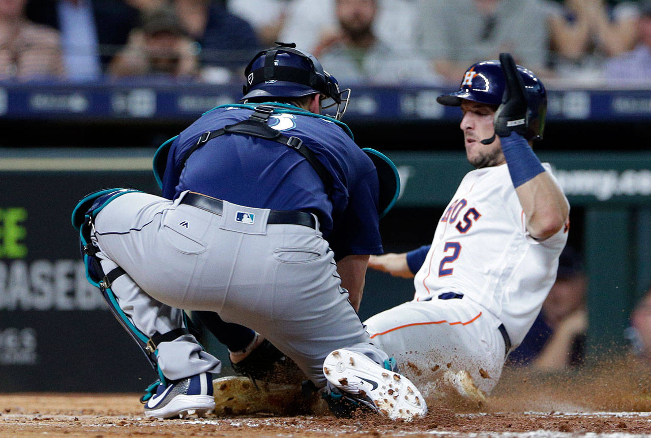 Mariners catcher Mike Zunino tags out the Astros’ Alex Bregman (2) during the third inning of a game June 6, 2018, in Houston. (AP Photo/Michael Wyke)