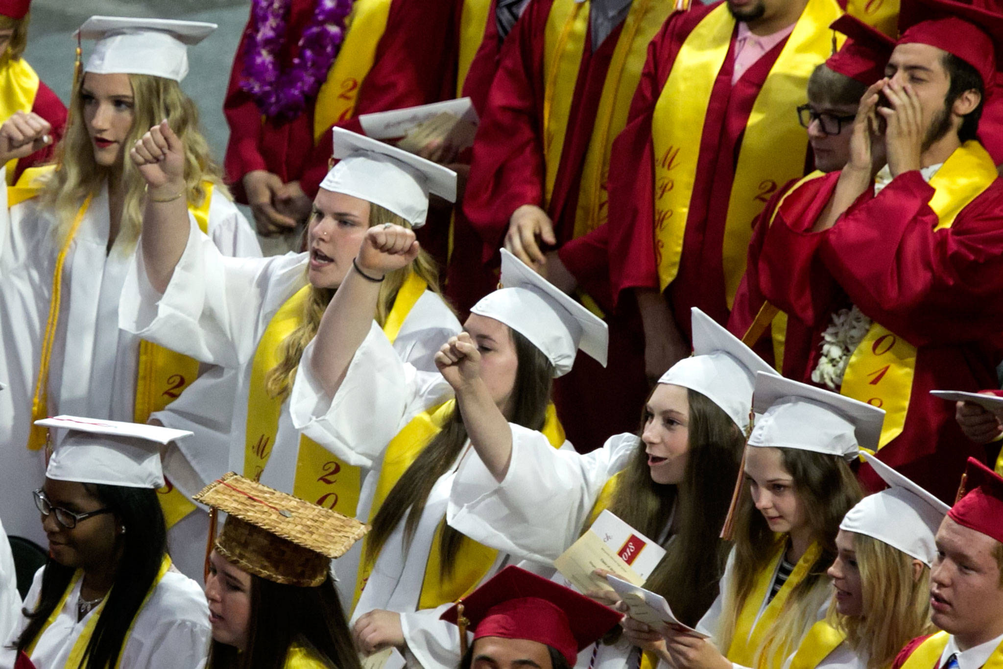 Students sing the fight song during the Marysville Pilchuck High School commencement at Angel of the Winds Arena on Wednesday night in Everett. (Kevin Clark / The Herald)