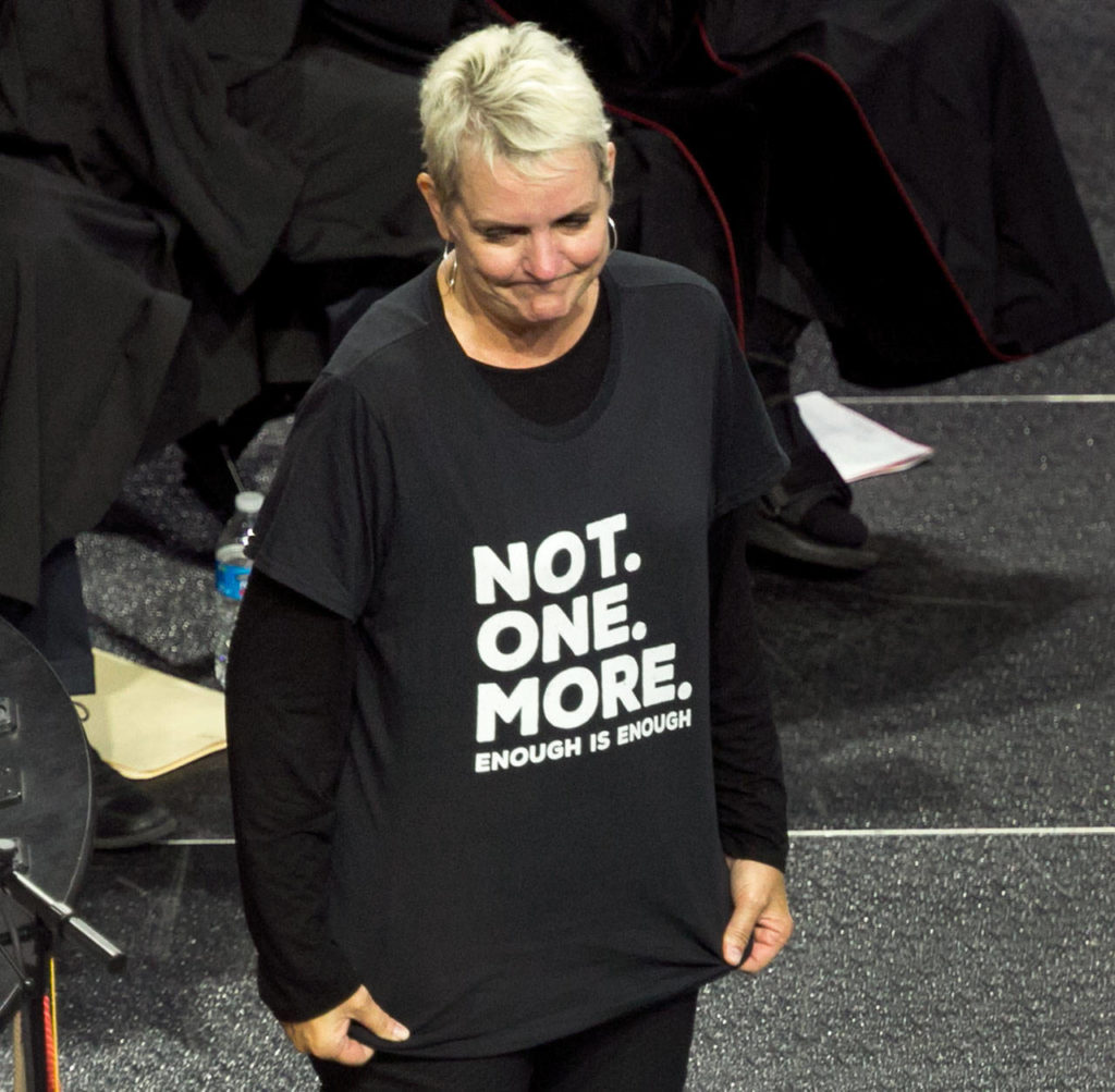 Becky Berg, immediate past Marysville superintendent, displays her shirt and its message during the Marysville Pilchuck High School class of 2018 commencement at Angel of the Winds Arena on Wednesday night in Everett. (Kevin Clark / The Herald) 
