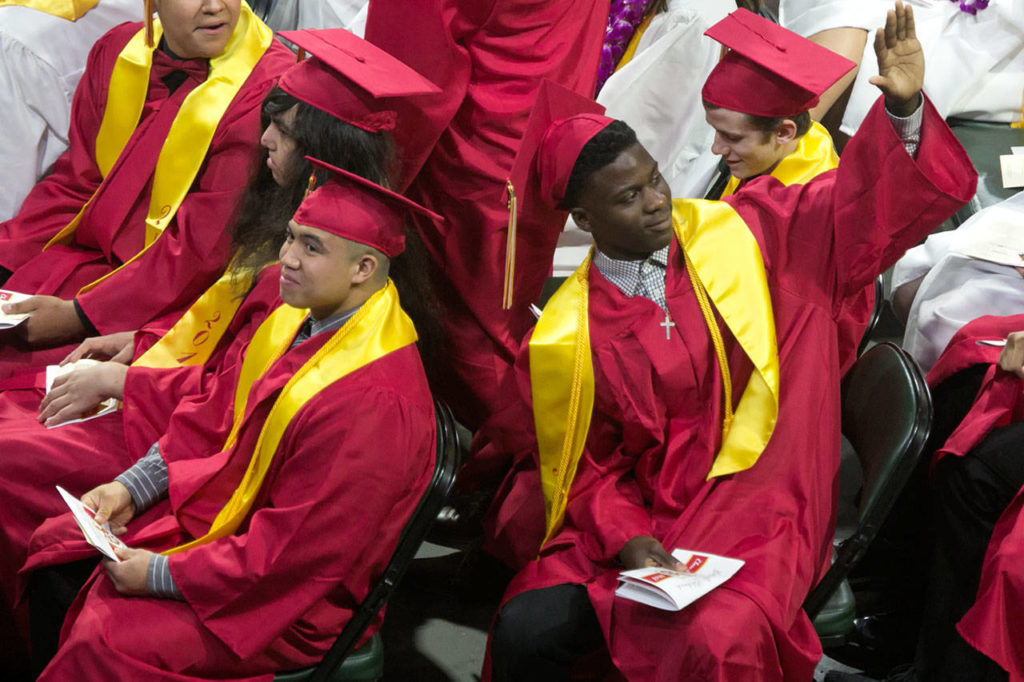 Students react to family and friends during the Marysville Pilchuck High School commencement at Angel of the Winds Arena on Wednesday night in Everett. (Kevin Clark / The Herald)
