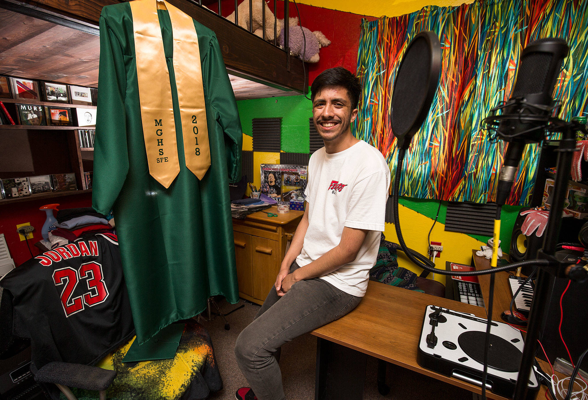 Daniel Garcia, aka the Y2Kid, the first baby born in Snohomish County at the dawning of a new millennium, in his room at home June 8 in Marysville surrounded by his hobbies, music, collections and thrift shop buys. Garcia graduates next week from Marysville Getchell High School and will attend Everett Community College in the fall. (Andy Bronson / The Herald)