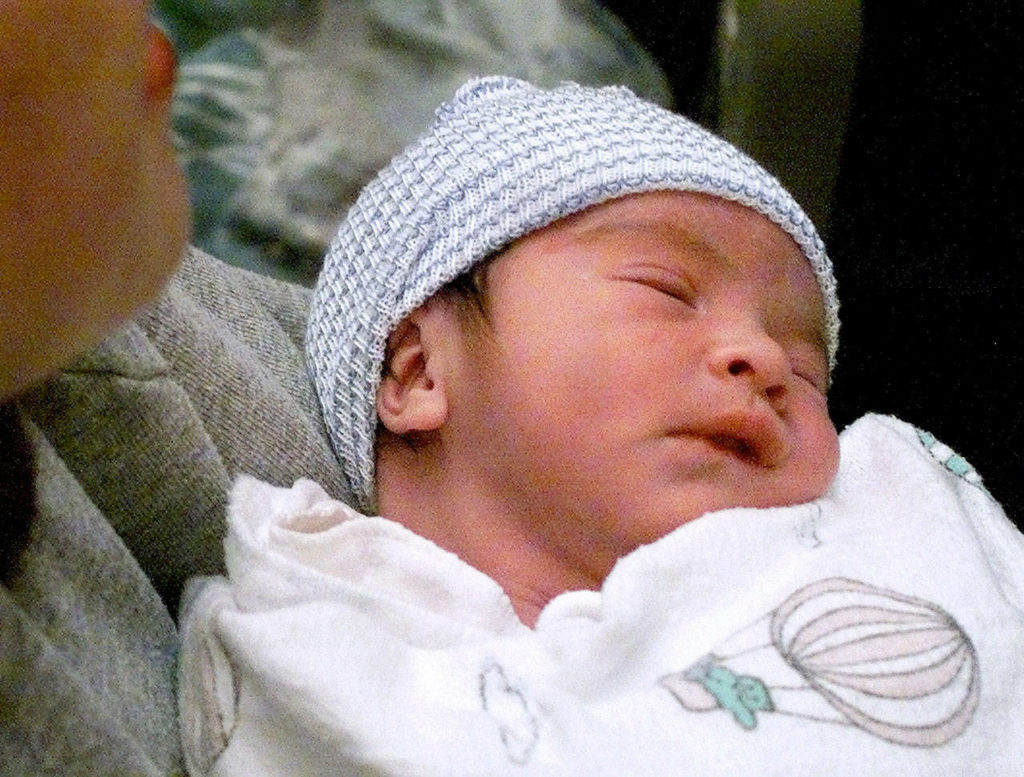 Daniel Garcia, the first baby born in Snohomish County in 2000, sleeps in his mother’s arms. (Herald file)
