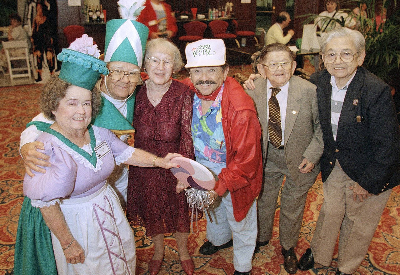 In this 1997 photo, cast members from “The Wizard of Oz” (from left), Margaret Pellegrini, Clarence Swensen, Ruth Duccini, Jerry Maren, Karl Slover and Mickey Carroll, appear at the Culver Hotel in Culver City, California, where they stayed during the filming of the movie. Maren, the last surviving munchkin from the classic 1939 film “The Wizard of Oz,” died on May 24, 2018, at a San Diego nursing home. He was 98. (AP Photo/Mark J. Terrill, File)