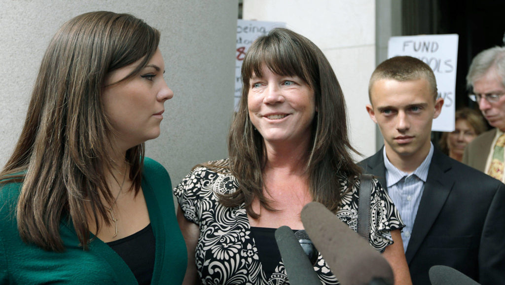 Plaintiff Stephanie McCleary (center) in 2014 with her children, Kelsey (left), then 20, and Carter, then 15, outside the state Supreme Court in Olympia (Elaine Thompson / AP file)
