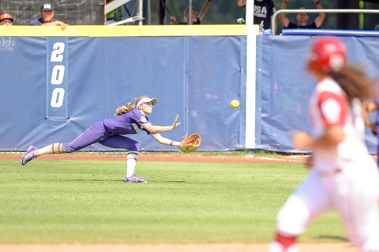 Washington senior Trysten Melhart, a Snohomish alum, makes a diving catch during a game against Oklahoma at the Women’s College World Series on May 31, 2018, in Oklahoma City. (Photo by Joshua R. Gateley)
