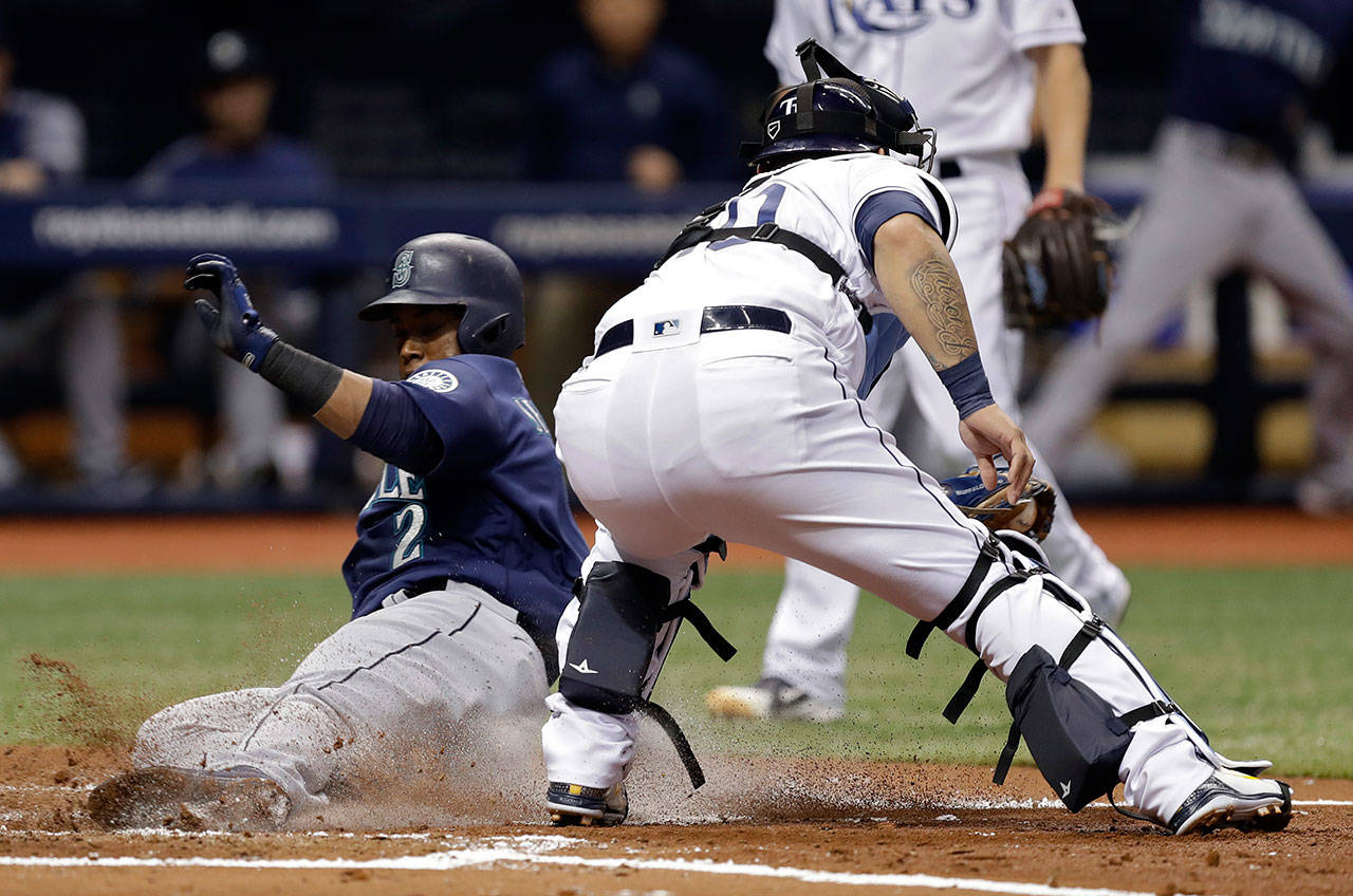 The Mariners’ Jean Segura (2) scores ahead of the tag by Rays catcher Wilson Ramos on a single by Mitch Haniger during the second inning of a game June 7, 2018, in St. Petersburg, Fla. (AP Photo/Chris O’Meara)