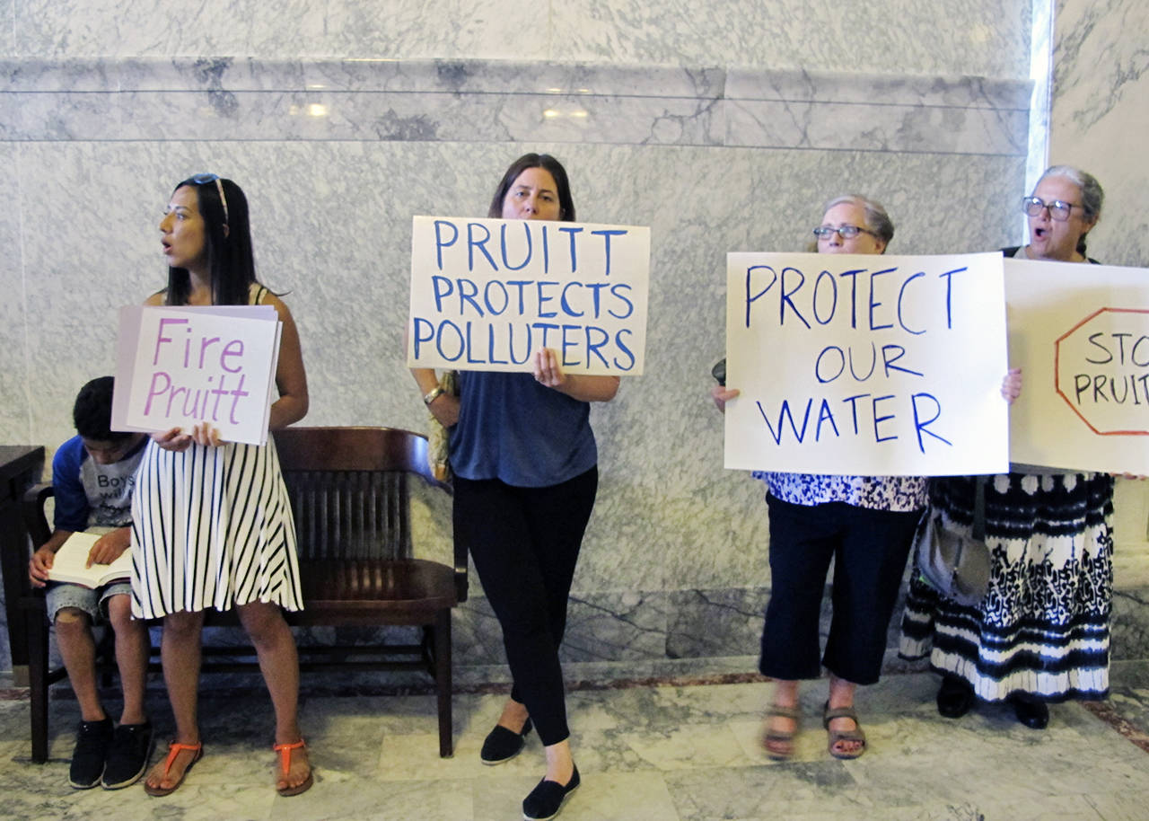 Activists gather outside Gov. C.L. “Butch” Otter’s ceremonial office to protest the U.S. Environmental Protection Agency Administrator Scott Pruitt’s visit in Boise, Idaho on Tuesday. Pruitt signed an agreement allowing Idaho to take over regulating pollution discharge into state lakes and rivers from the federal government. (AP Photo/Kimberlee Kruesi)
