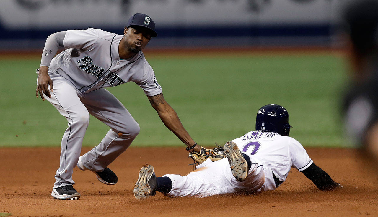 Seattle’s Dee Gordon tags out Tampa Bay’s Mallex Smith trying to steal second base during the eighth inning of Saturday’s game in St. Petersburg, Fla. (AP Photo/Chris O’Meara)