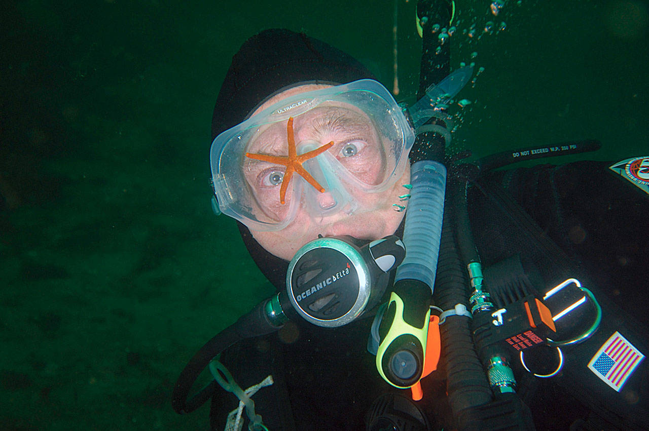 Diver Jay Sprenger, with a sea star on his face mask. (Photo Dan Clements)