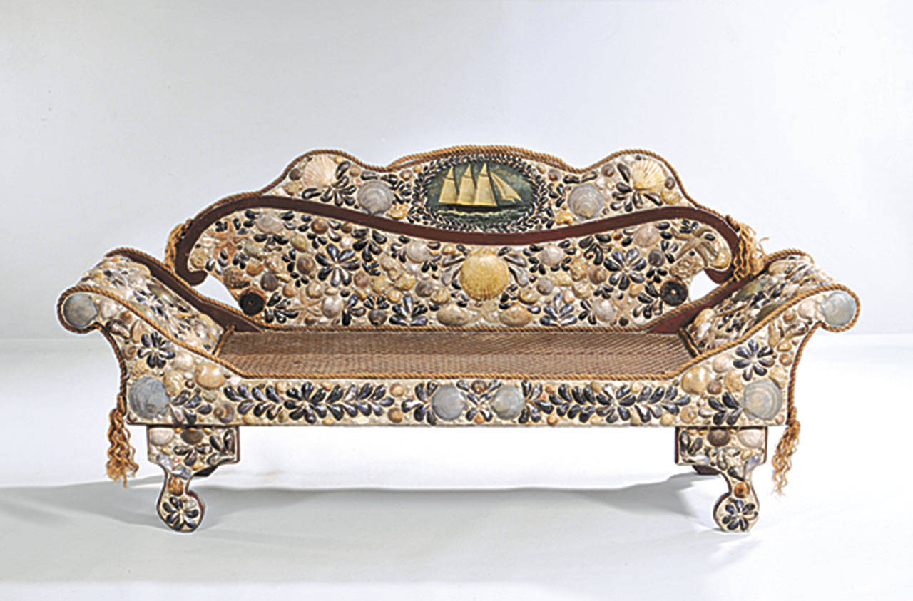 Not everyone would want this unique antique sofa from New Brunswick, Canada. It is a piece of unique and attractive folk art by a talented maker. It took time to collect and mount all the shells, and a bidder paid almost twice the estimate to buy it for $4,613. (Cowles Syndicate Inc.)