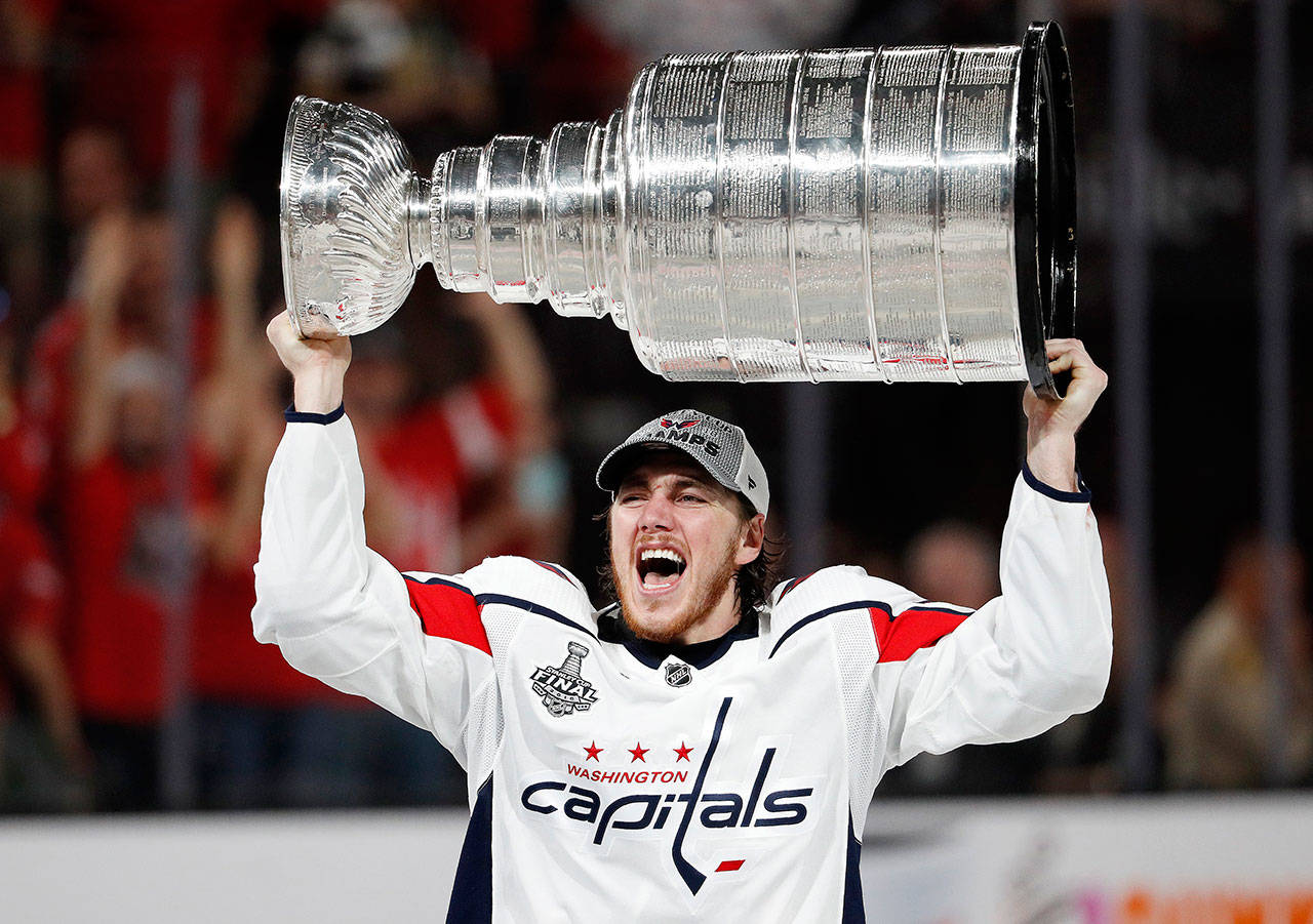 Washington’s T.J. Oshie, a Snohomish County native, hoists the Stanley Cup after the Capitals defeated Vegas 4-3 in Thursday’s Game 5 to win the Stanley Cup Finals. (AP Photo/John Locher)