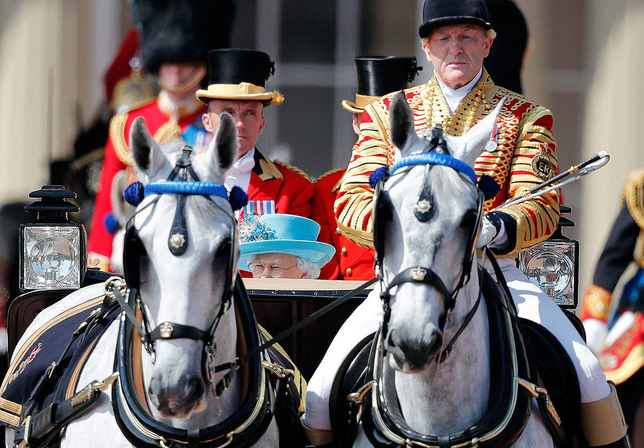 Britain’s Queen Elizabeth rides in a carriage to attend the annual Trooping the Color ceremony in London on Saturday. (AP Photo/Frank Augstein)