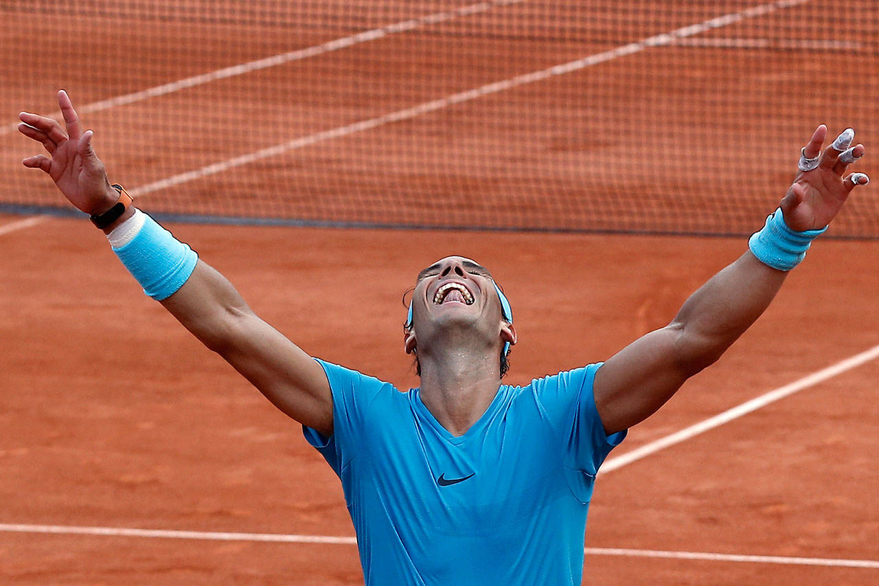 Spain’s Rafael Nadal celebrates winning the men’s final match of the French Open tennis tournament against Austria’s Dominic Thiem in three sets 6-4, 6-3, 6-2, at the Roland Garros stadium in Paris, France, Sunday, June 10, 2018. (AP Photo/Michel Euler)