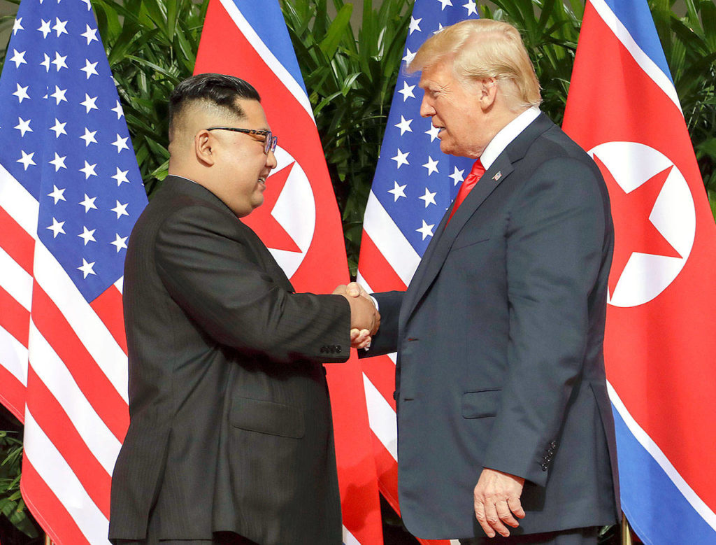 U.S. President Donald Trump shakes hands with North Korean leader Kim Jong Un at the Capella resort on Sentosa Island on Tuesday in Singapore. (AP Photo/Evan Vucci) 
