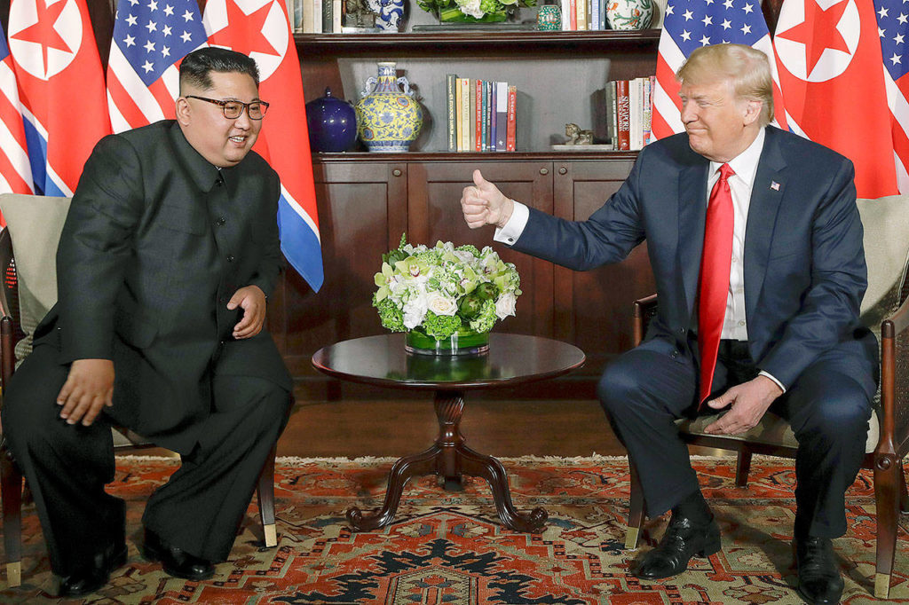 U. S. Donald Trump gives North Korea leader Kim Jong Un a thumbs-up at their meeting at the Capella resort on Sentosa Island Tuesday in Singapore. (AP Photo/Evan Vucci) 
