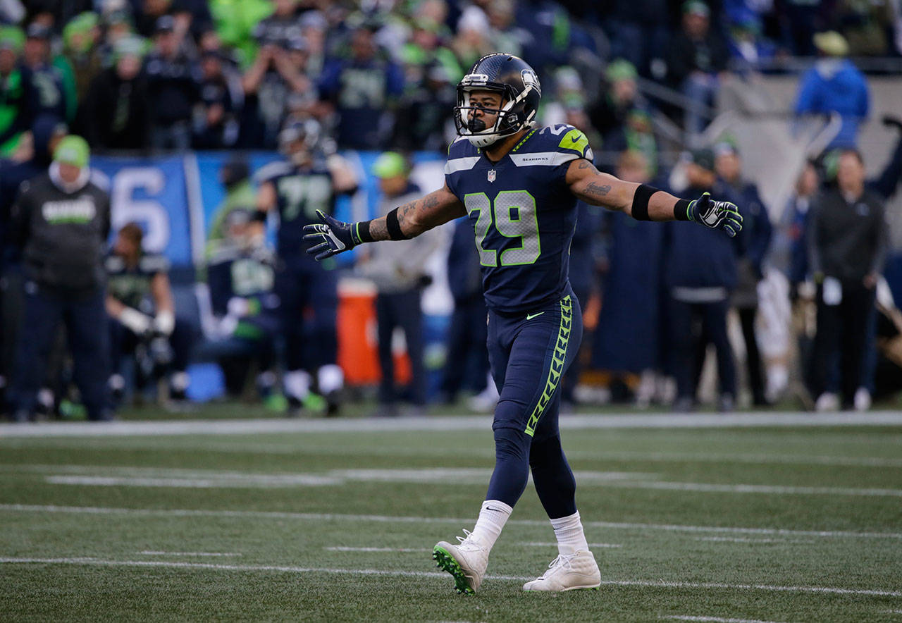 Seattle Seahawks free safety Earl Thomas walks on the field during the first half of an NFL football game Dec. 31, 2017 against the Arizona Cardinals in Seattle. He is skipping mandatory team activities in hopes of getting a new contract. (AP Photo/John Froschauer)