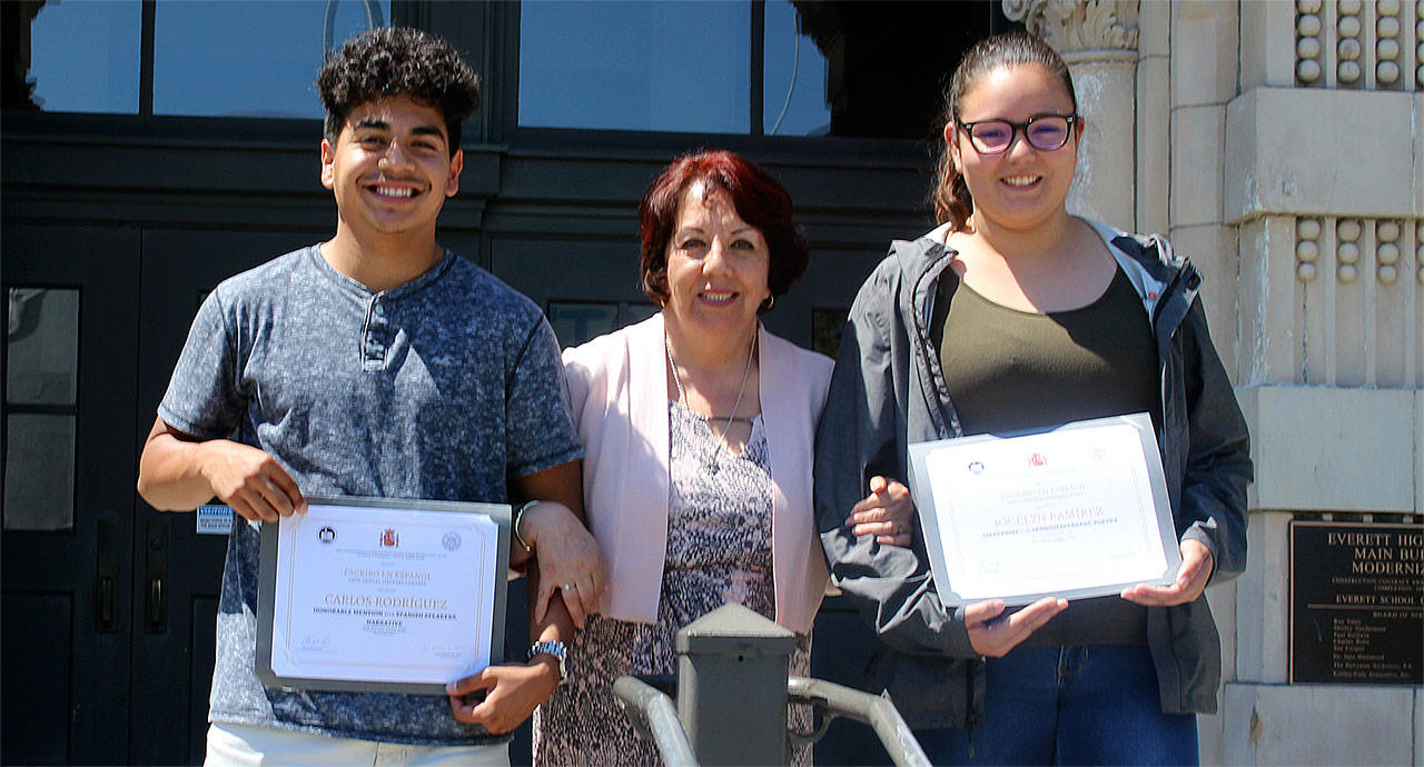 Everett High School student Carlos Rodriguez (from left), AP Spanish teacher Margarita Hurtado and student Jocelyn Ramirez celebrate top awards in the 20th annual “Yo escribo en Español” literacy contest. (Contributed photo)
