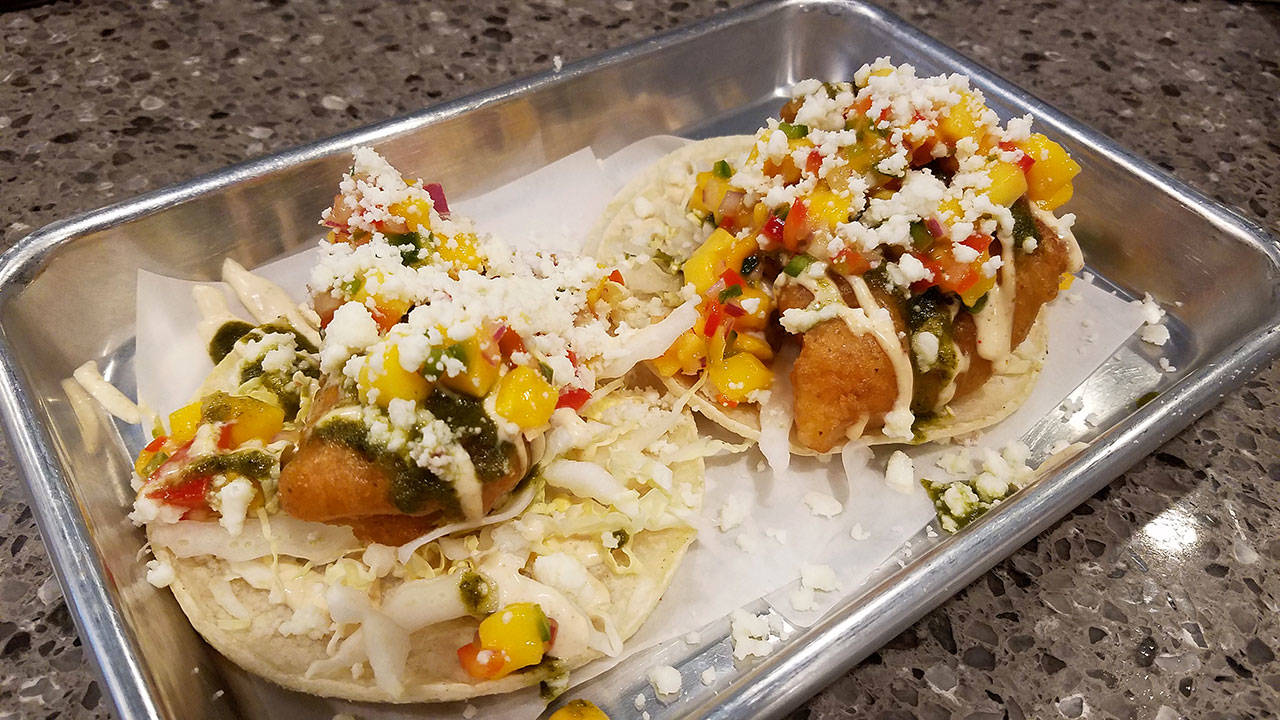 The fish tacos, with rock fish and mango salsa, is one of offerings at Mar-ket Fishmonger & Eatery in Edmonds, which specializes in takeout food and selling fresh seafood. (Sharon Salyer / The Herald)