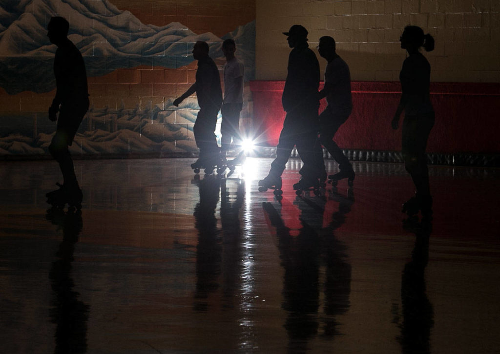 Skaters make their way around the rink Thursday night during Adult Open Skate at Lynnwood Bowl and Skate in Lynnwood on June 14, 2018. (Kevin Clark / The Herald)
