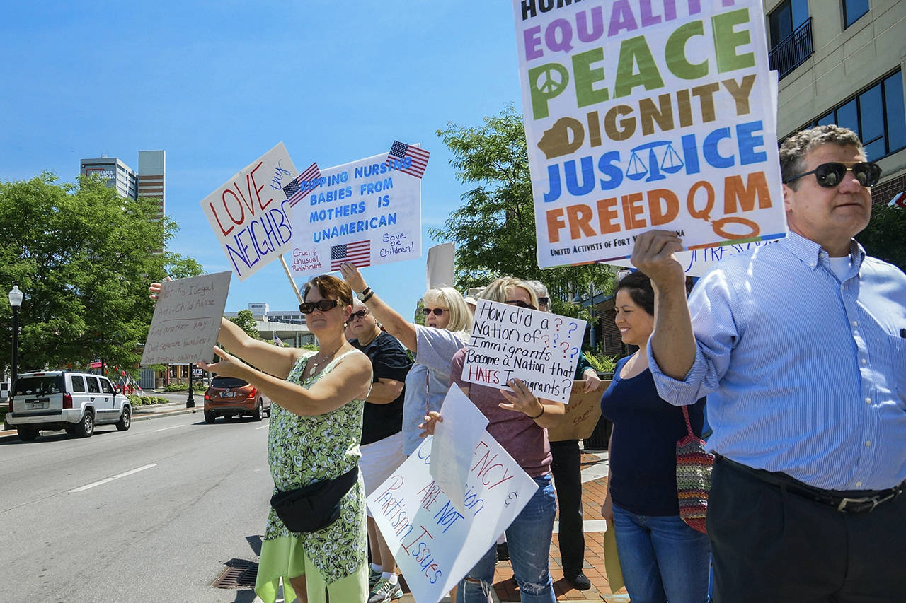 People line up to protest U.S. Attorney General Jeff Sessions and immigration reform at Parkview Field in Fort Wayne, Indiana, on Thursday. (Mike Moore/The Journal-Gazette via AP)