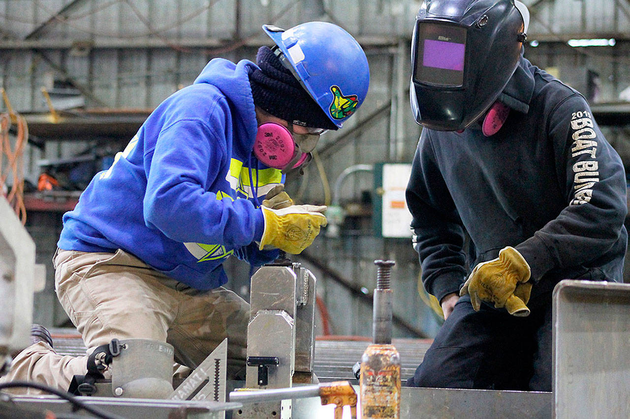 Nichols Brothers Boat Builders apprentice Janette Alhanati (left) and journeyman Kurt Warwick construct wall panels for an upcoming boat project with Linblad Expedition Holdings. A federal grant from the Northwest Workforce Council allowed Nichols Brothers to add more apprentices to its workforce in January. (Herald file photo)