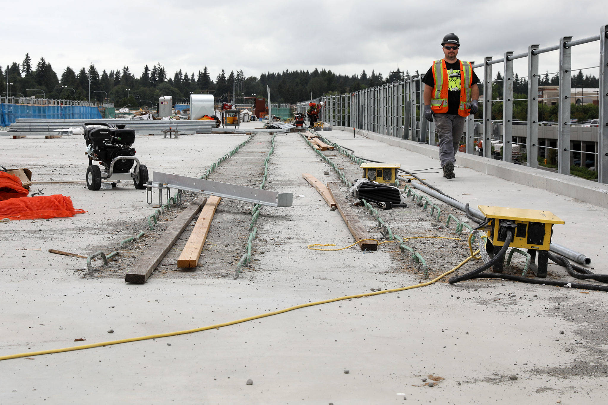 Workers begin laying the light rail track at the future Northgate Station. (Lizz Giordano / The Herald)