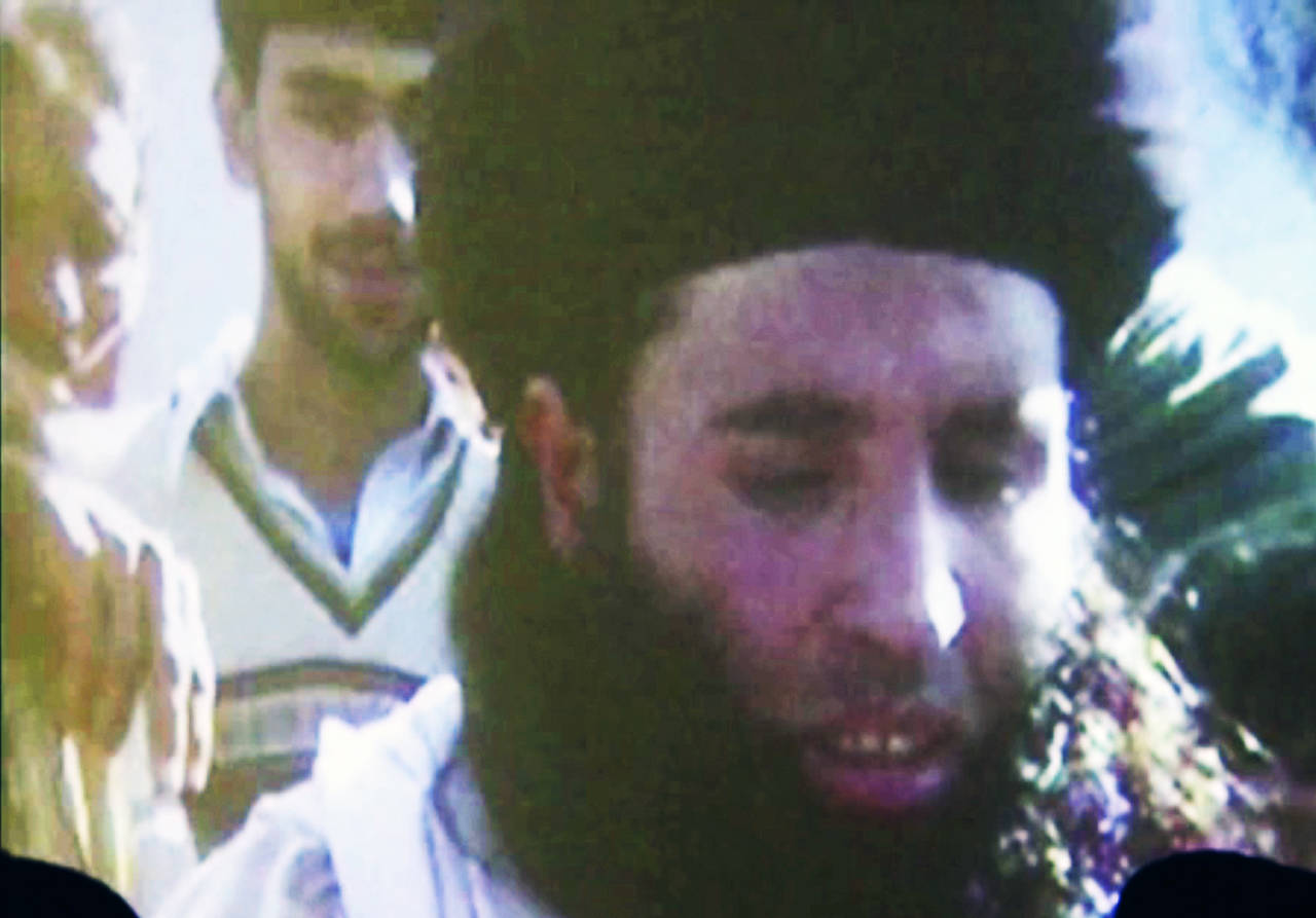 In this file image made from video broadcast on Nov. 7, 2013, undated footage of Mullah Fazlullah is shown on a projector in Pakistan. (AP Photo via AP Video, File)