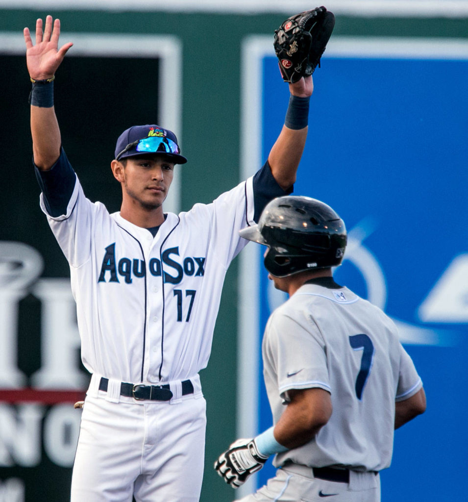 The AquaSox’s Nick Rodriguez (left) signals with the Hops’ Jose Caballero safe at second during a game on June 15, 2018, at Everett Memorial Stadium. (Kevin Clark / The Herald)
