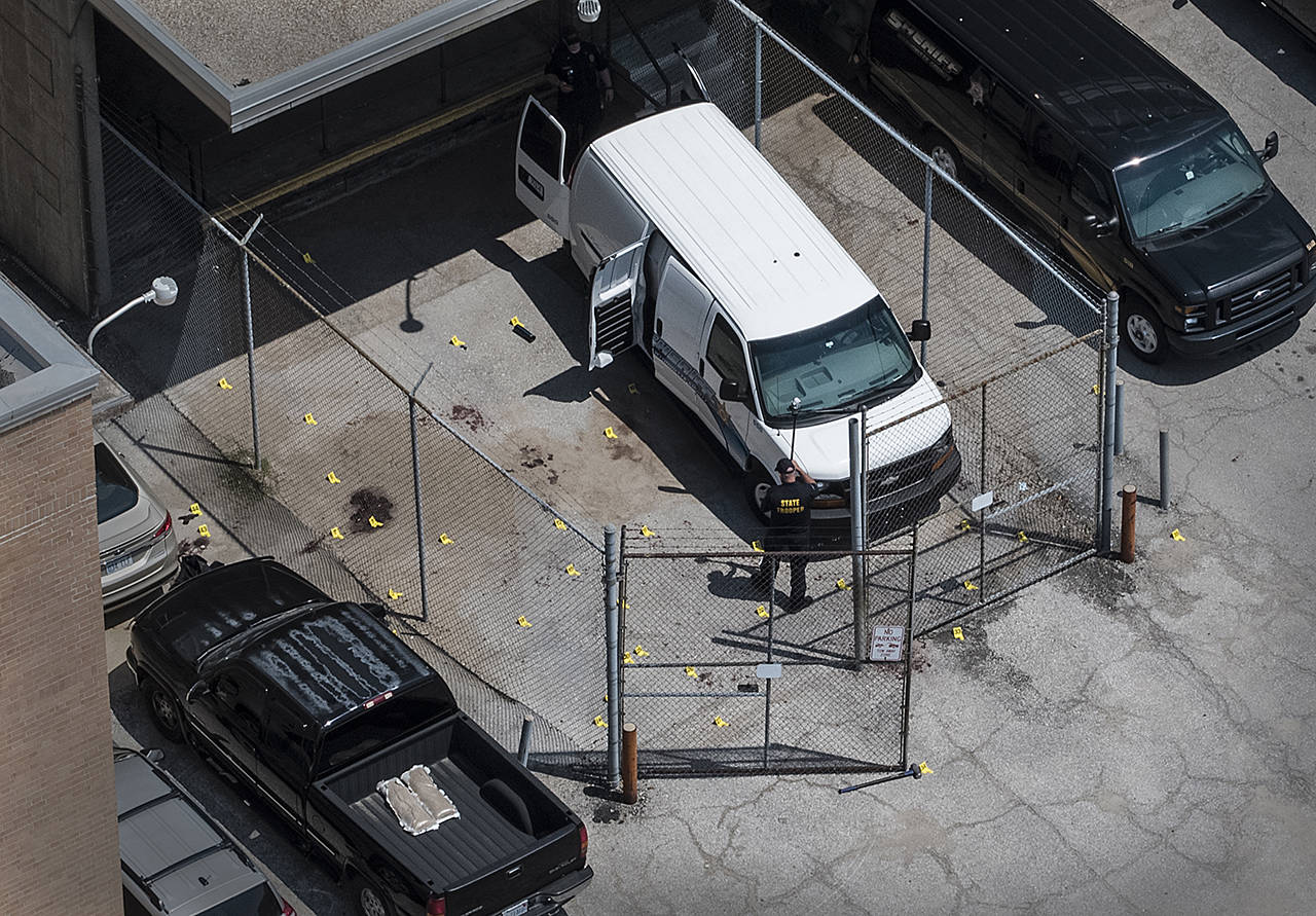 Evidence markers dot the pavement just outside the Wyandotte County courthouse Friday in Kansas City, Kansas. (The Kansas City Star via AP)