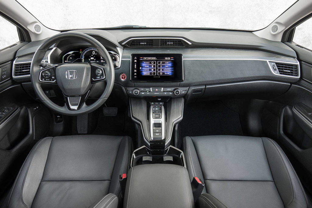 The 2018 Honda Clarity Plug-in Hybrid interior mimics the exterior’s interesting angular shapes. Extra storage space is available beneath the floating center console. (Manufacturer photo)
