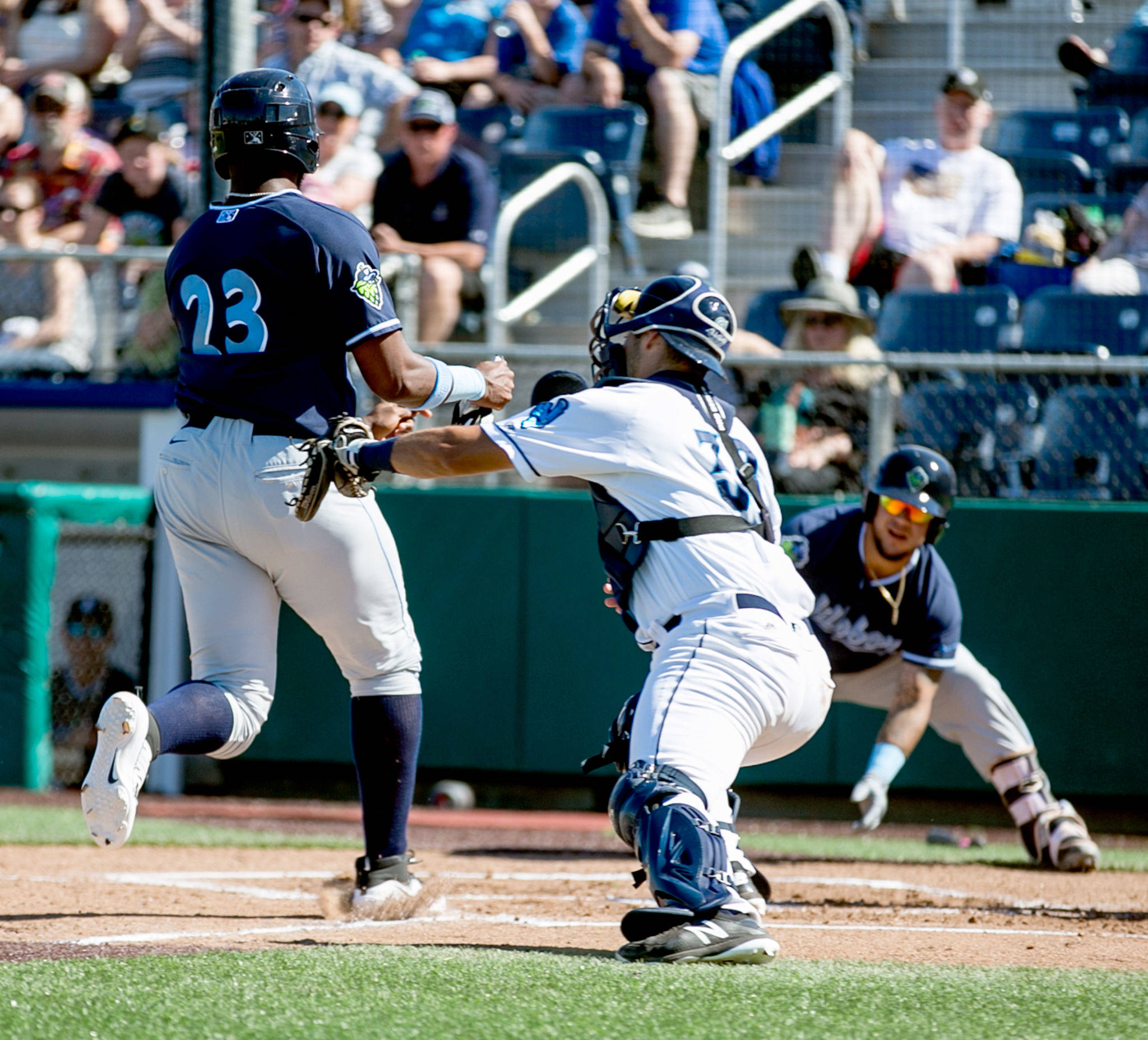 Hops’ Francis Martinez avoids a tag attempt by Aquasox’s Jake Anchia Sunday afternoon at Everett Memorial Stadium in Everett on June 17, 2018. (Kevin Clark / The Herald)