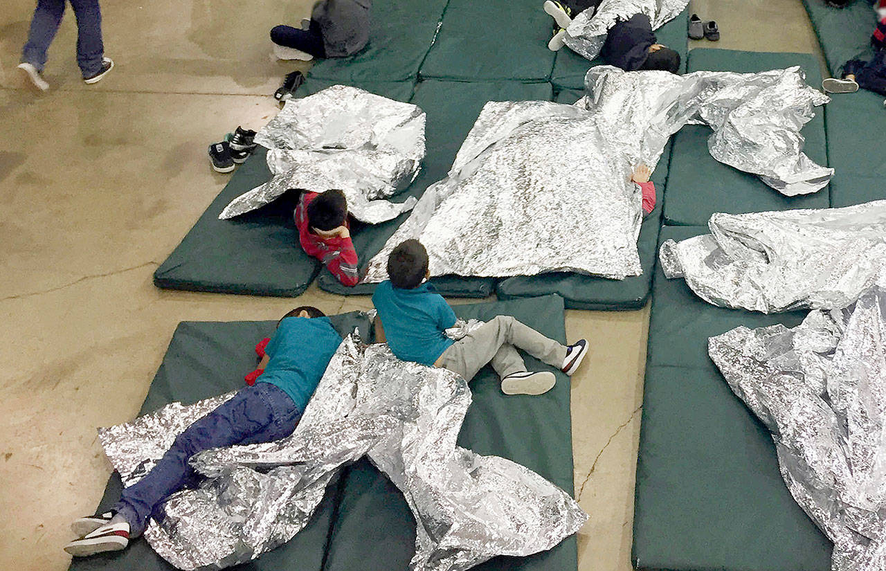 People who have been taken into custody in cases of illegal entry into the United States rest in one of the cages at a facility in McAllen, Texas, on Sunday. (U.S. Customs and Border Protection’s Rio Grande Valley Sector via AP)