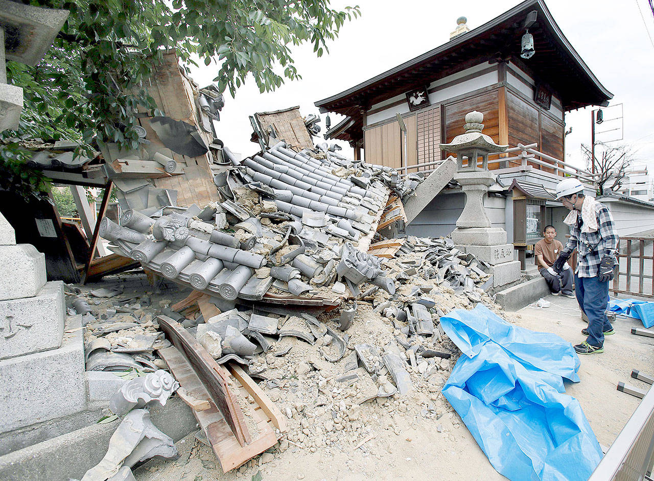 The gate of Myotoku-ji temple collapsed after an earthquake hit Osaka, Japan, on Monday. (Yosuke Mizuno/Kyodo News via AP)