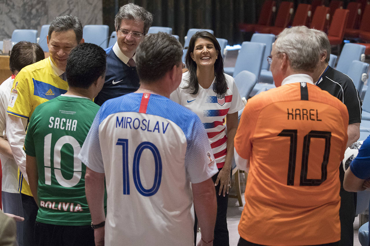 American Ambassador to the United Nations Nikki Haley (center) speaks to other members of the Security Council before posing for a photo wearing the jerseys of their country’s soccer teams on Thursday at United Nations headquarters. (AP Photo/Mary Altaffer)