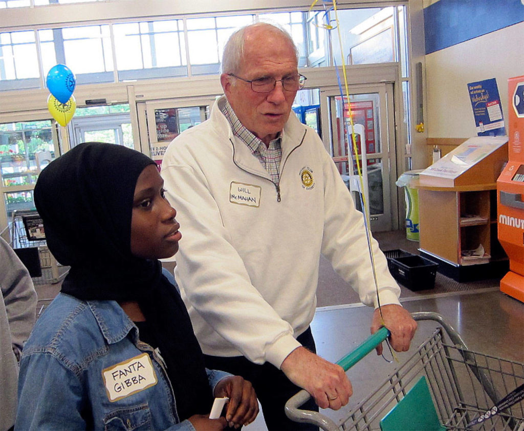 With help from Rotary of Everett President Will McMahan, Cascade High School graduate Fanta Gibba sets out June 7 to find College Essentials items at the Mill Creek Fred Meyer store. Rotary provides ten students in the AVID program with $500 grants to buy college needs. (Contributed photo)
