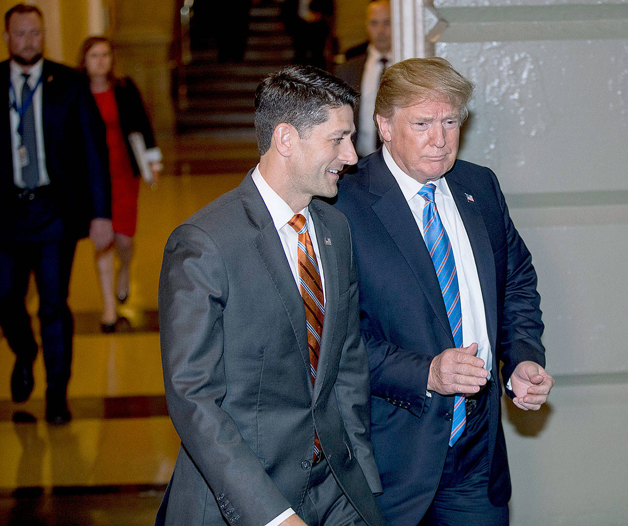 President Donald Trump, accompanied by Speaker Paul Ryan of Wisconsin, arrives on Capitol Hill in Washington on Tuesday to meet with Republican members of the House of Representatives. (AP Photo/J. Scott Applewhite)