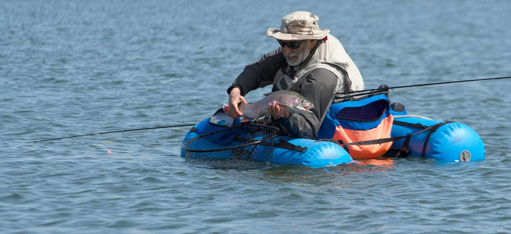 Rick Bowzer prepares to release a nice rainbow trout. (Photo by Mike Benbow)
